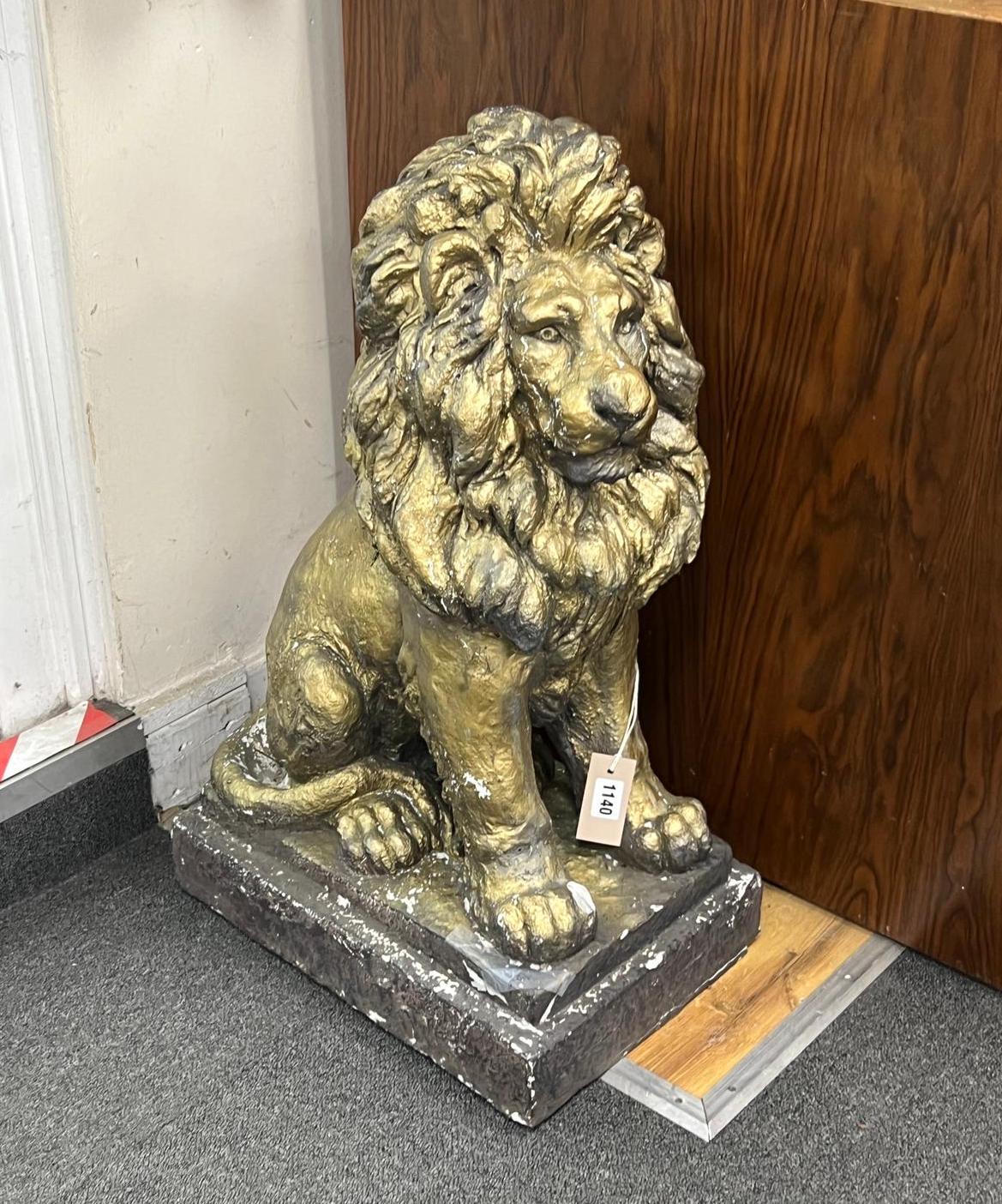 A painted composition faux stone lion garden ornament, height 65cm